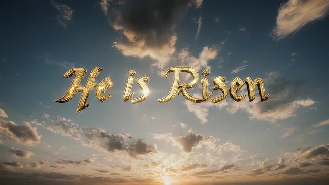 Golden "He is Risen" on a bright, cloudy sky at sunset