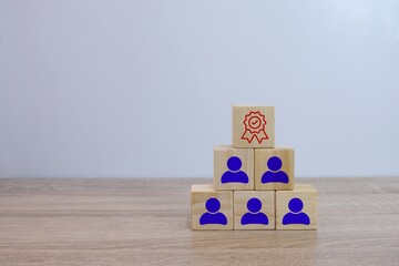Conceptual pyramid of wooden blocks representing employee recognition and achievement