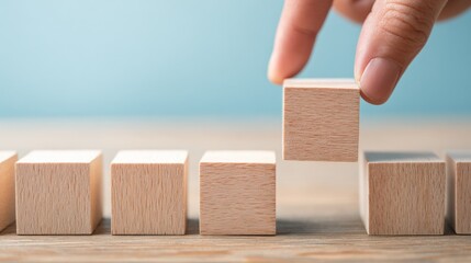 Hand Placing a Wooden Block, Building Success, and Leadership Concept on a Wooden Table
