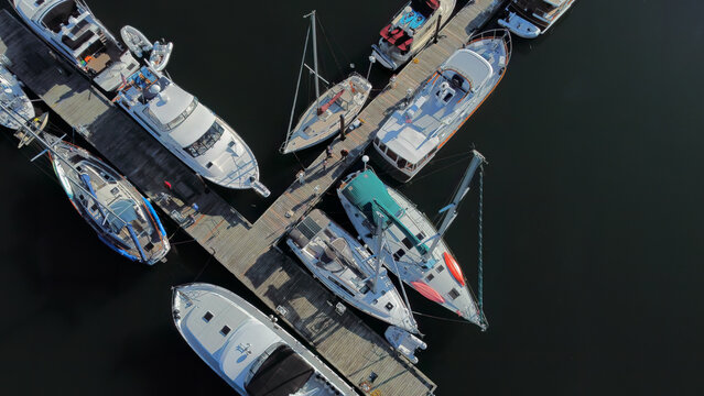 An aerial shot overhead of a Pacific Northwest yacht club outstation dock where all types of boats hang out for a weekend of fun on the water.