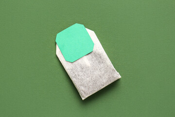 Tea bag with label on green background
