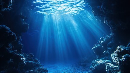 Fototapeta premium Deep blue ocean scene with shafts of sunlight filtering through the surface, illuminating the depths
