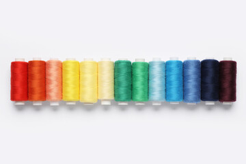 Set of different thread spools on white background