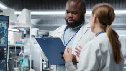 Two researchers testing a patient during a drug trial and recording side effects, monitoring dosage and studying allergic reactions. Biotechnology and clinical research. Camera B.