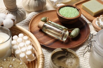 Beautiful composition with spa essentials on light fabric, closeup