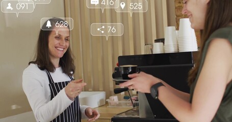 Serving barista in apron passing coffee cup to customer behind counter with machine, copy space