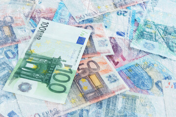 Money under ice. Many euro bills frozen