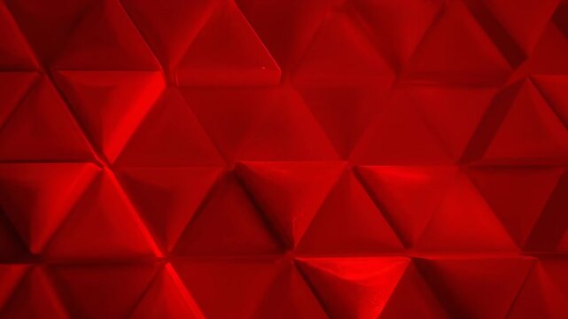 Dynamic geometric red pattern abstract background with repeating triangular shapes smoothly transitioning and pulsing creating a modern digital backdrop power, creative, dynamic geometric