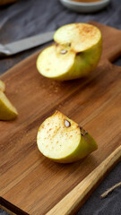 Sliced Apple with Cinnamon on a Cutting Board