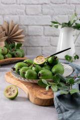 Fresh green feijoa fruit with a small spoon