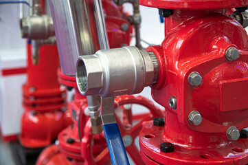 A red fire hydrant with a blue ball valve