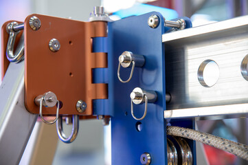 A blue and orange piece of equipment with a silver hole in the middle