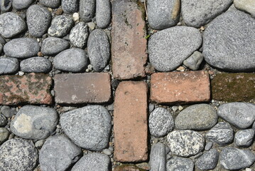 Background made with stones, bricks, and a tree stem