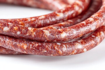 Macro Closeup of Dry Cured Smoked Sausage String with Natural Casing on White Surface