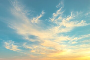 Fototapeta premium Wispy Clouds Streaking Across a Vibrant Blue Sky at Sunset or Sunrise
