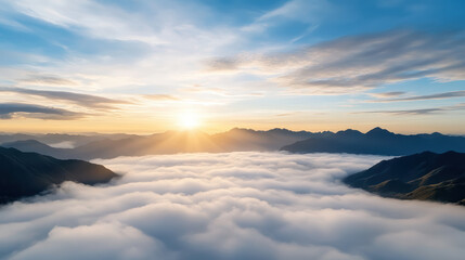 Soft morning mist under pale blue sky creates calm and dreamy atmosphere over mountains
