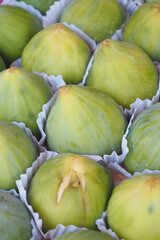 Fresh figs arranged in display at a local market stall