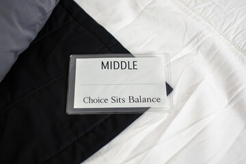 Clear card featuring Middle text resting on black and white divided fabric