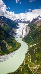 A breathtaking aerial view showcasing majestic mountains with snow-capped peaks, winding rivers glistening under the sun, and lush green valleys below.