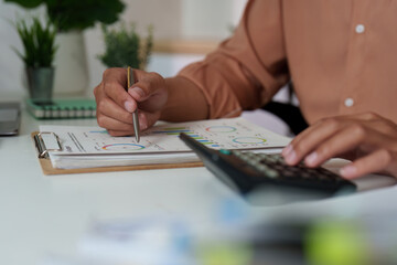 Budget Management. Professional calculating financial data with charts and calculator.