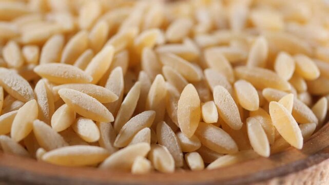 Cooking orzo pasta with fresh ingredients for a healthy meal