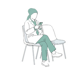 Healthcare professional wearing hijab and lab coat sits in waiting room, looking at her phone
