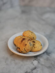Golden cookies with melty chocolate, one broken to reveal soft interior