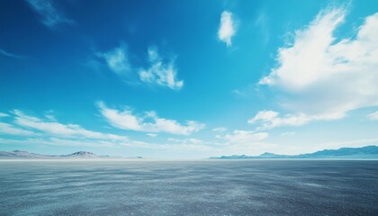 Fototapeta premium Vast, flat desert landscape under a bright blue sky with fluffy white clouds