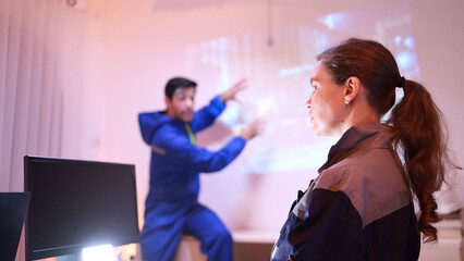 Engineers and industrial workers in safety uniforms discussing a tunnel construction