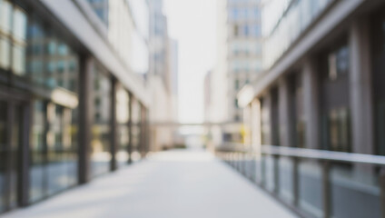 Blurred modern walkway between tall office buildings on a bright day, capturing the soft glow of sunlight reflecting off glass surfaces and creating a serene yet dynamic urban perspective.