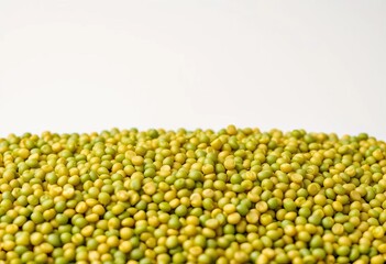 Close-up of scattered green lentils against a plain background,   abundance,  background