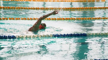 Competitive Swimmer in Action: Demonstrating Skill and Determination While Navigating the Pool Lanes, Capturing the Essence of Athletic Excellence and Focus