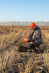  Hunter holding first aid kit at autumn field. personal first aid kit. health problem in hunting.