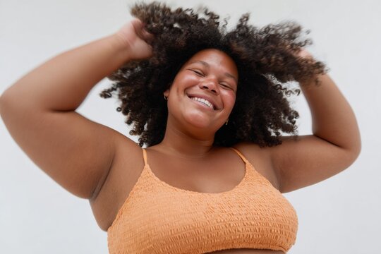 Authentic plus size woman confidently embracing natural beauty with joyful expression Premium lifestyle content for modern self-love and body positivity campaigns