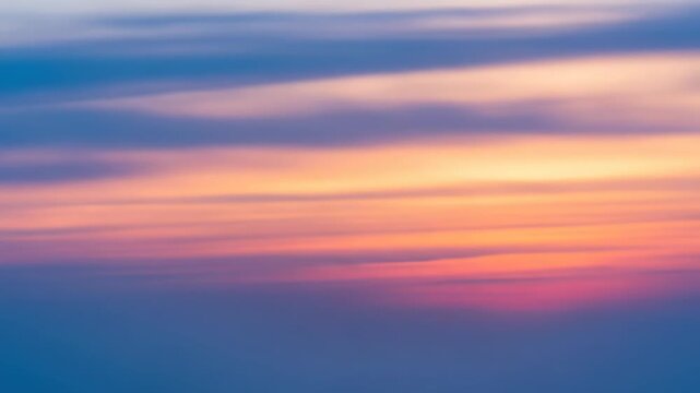 Abstract gradient of blended orange, pink, and blue hues, softly diffused