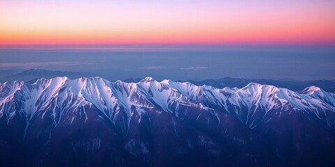 Blush sunset over a tranquil, snow-capped mountain range, magical, rocks