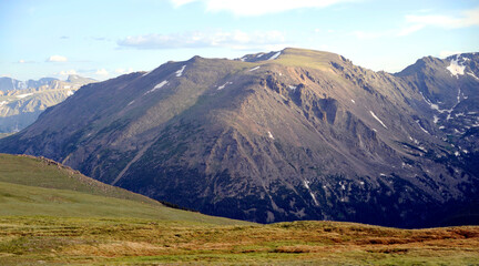 Snow-capped Alps mountains landscape with a green valley and a blue sky in summer