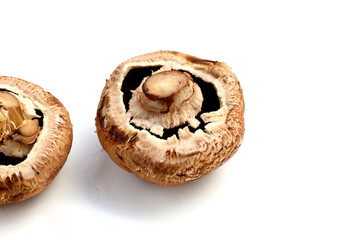 Fresh portobello mushrooms with visible gills underneath.