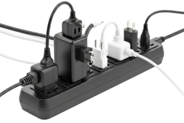 Overloaded black power strip with many plugs and adapters on a transparent background