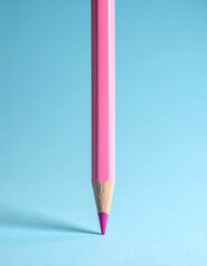 Pink pencil against light blue