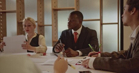 Business colleagues review data and collaborate on a project during a productive meeting. - Powered by Adobe