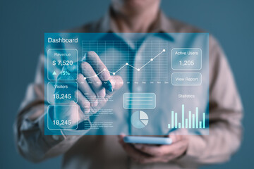 Businessman using digital dashboard interface with revenue metrics, visitor stats, and data...