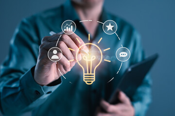 Creative light bulb and digital strategy icons with businessman using stylus, symbolizing innovation, teamwork, idea generation, and modern business intelligence