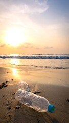 Plastic bottle on a beach at sunrise