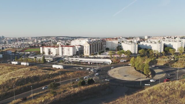 Drone aerial over Amadora, Portugal showing busy traffic and urban scenery around Parque das Artes e do Desporto area.