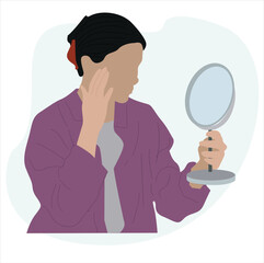woman looking in the mirror. woman looking at herself in mirror.