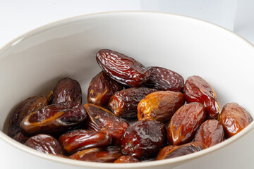 Bowl of dried dates - white background