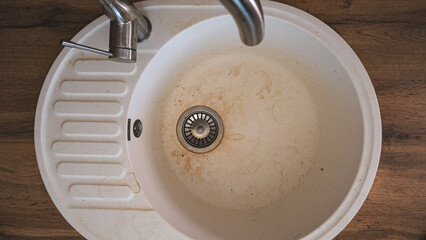 Dirty empty stone sink in the kitchen, top view