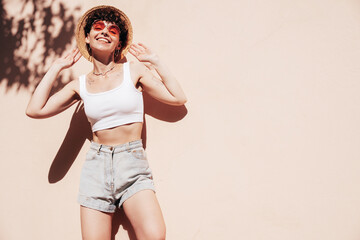 Young beautiful smiling hipster woman in trendy summer shorts and top white t-shirt. Carefree woman...