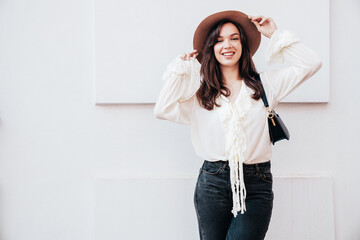 Young beautiful smiling hipster woman in trendy summer white blouse and jeans. Carefree woman...